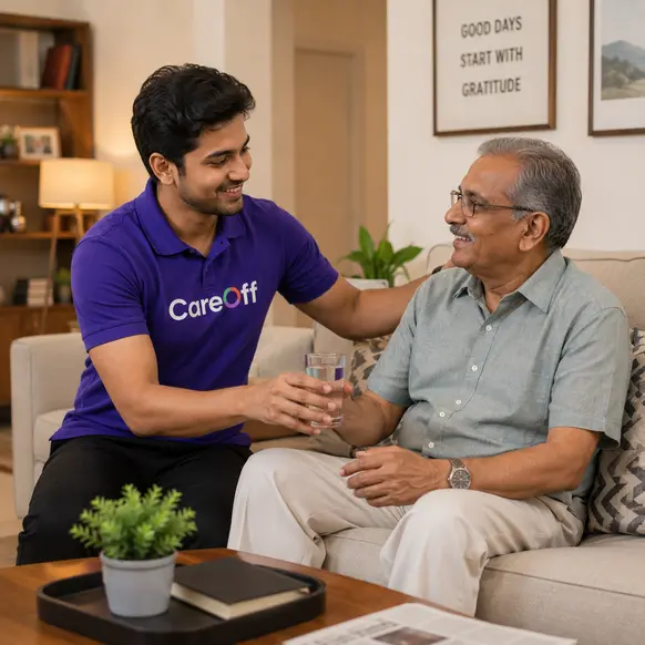 CareOff companion handing a glass of water to an elderly man at home in Bengaluru